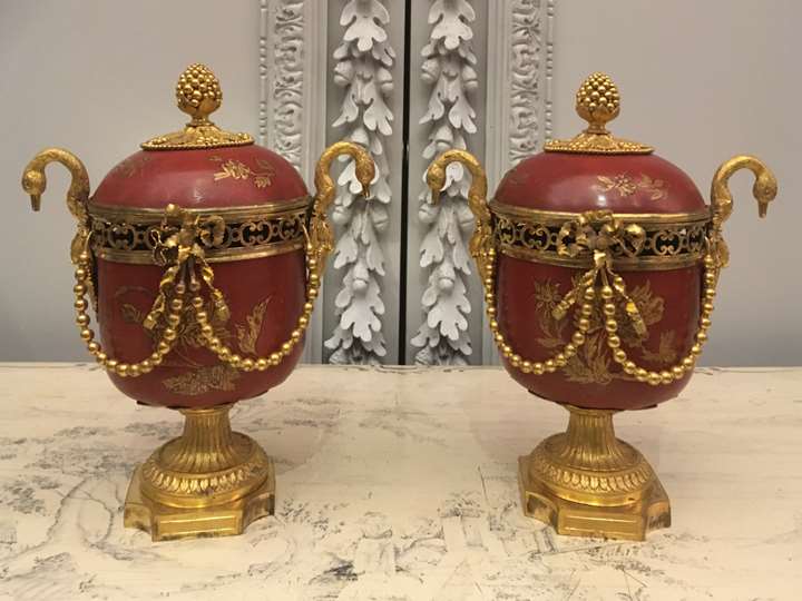 A pair of ormolu-mounted red lacquer potpourri vases with swan handles